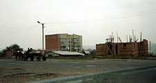 a church being built in orshivtsi across the street from the hospital. the low silver building (shack) to the left is the existing church. the brick, mortar, & plaster construction is typical of 99.9% of buildings going up in ukraine.